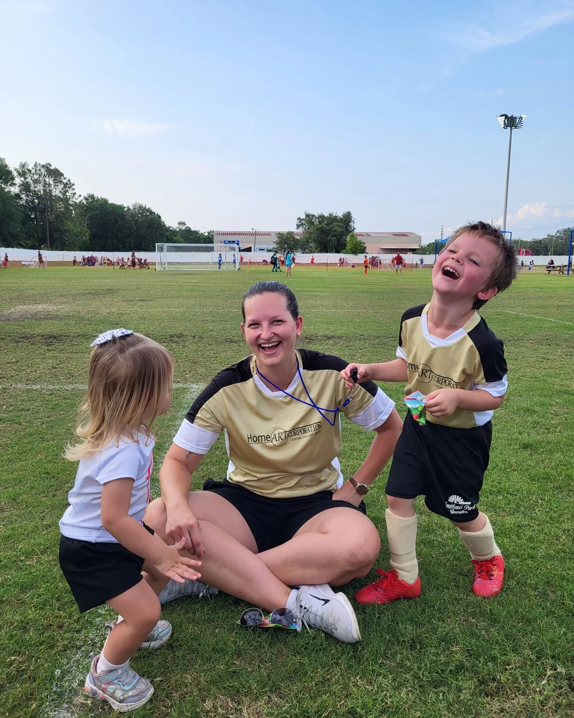 L'ren coaching her children Leo and Lily on a soccer field