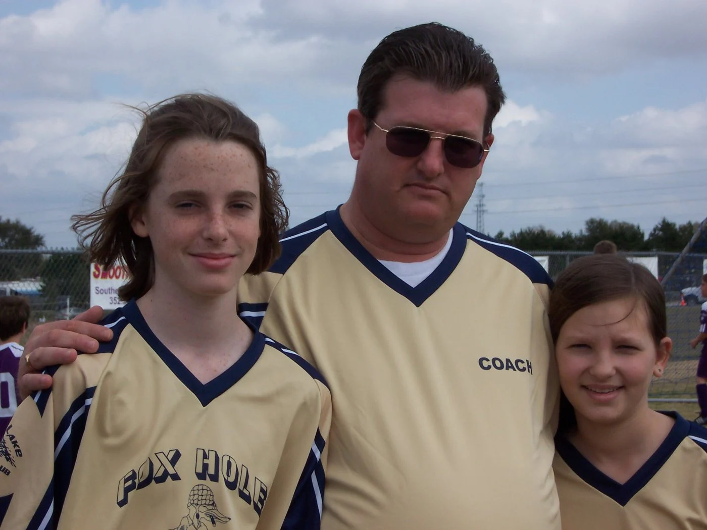 Coach Ken with two of his soccer players in 2006
