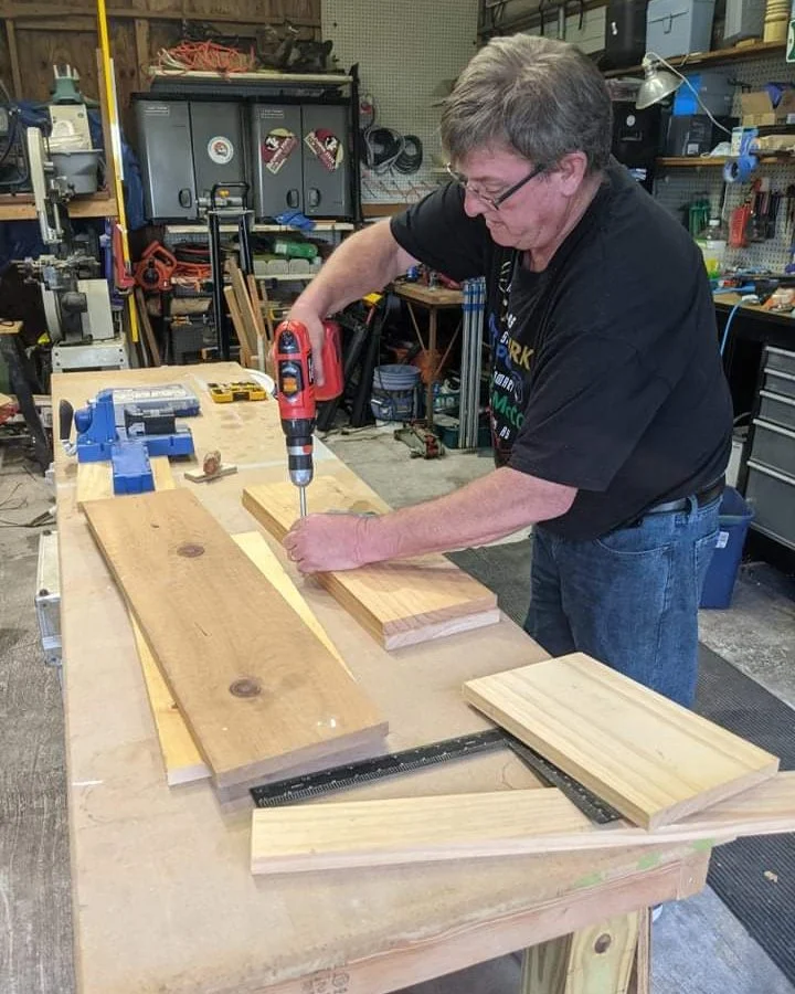 Ken drilling a board at his workbench
